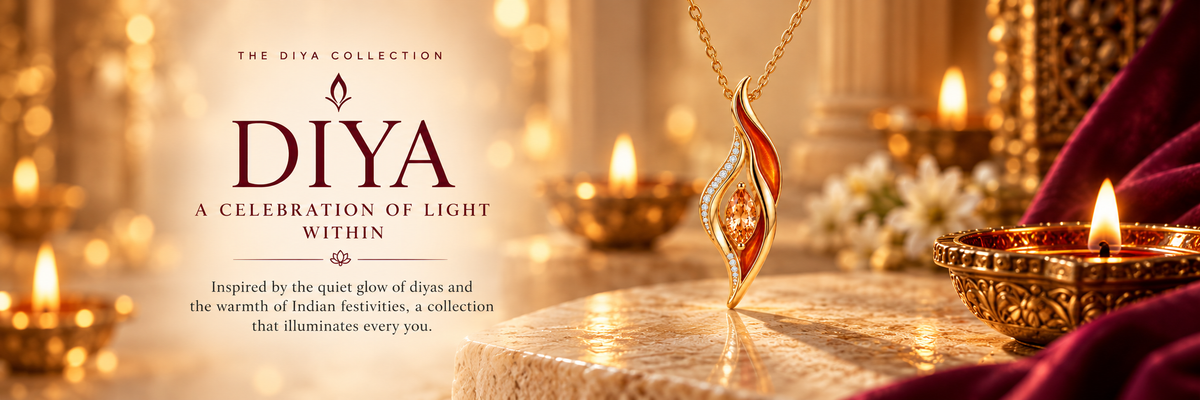 Diya pendant in rose gold with orange enamel beside glowing diyas